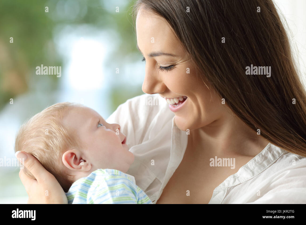 Proud mother holding her baby and looking each other Stock Photo