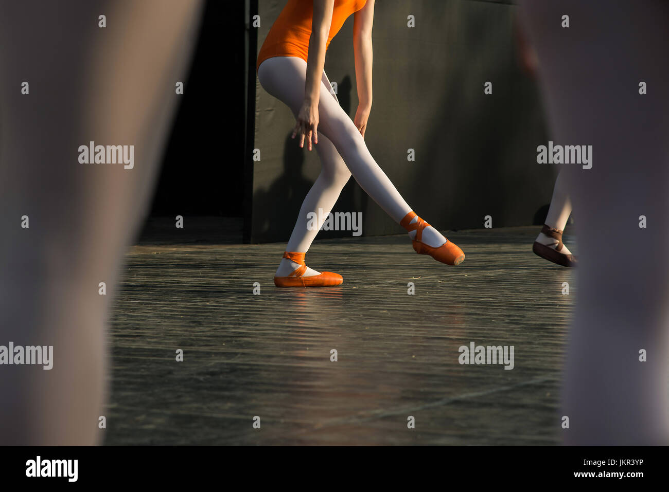 Ballerina feet dancing on ballet shoes on stage during a performance. Stock Photo