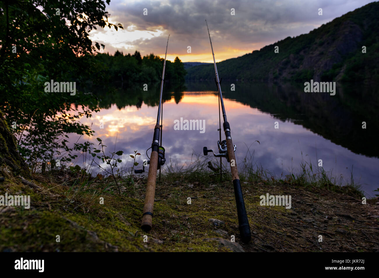 Freshwater fishing with rods on Vltava at sunset, Czech Republic Stock Photo