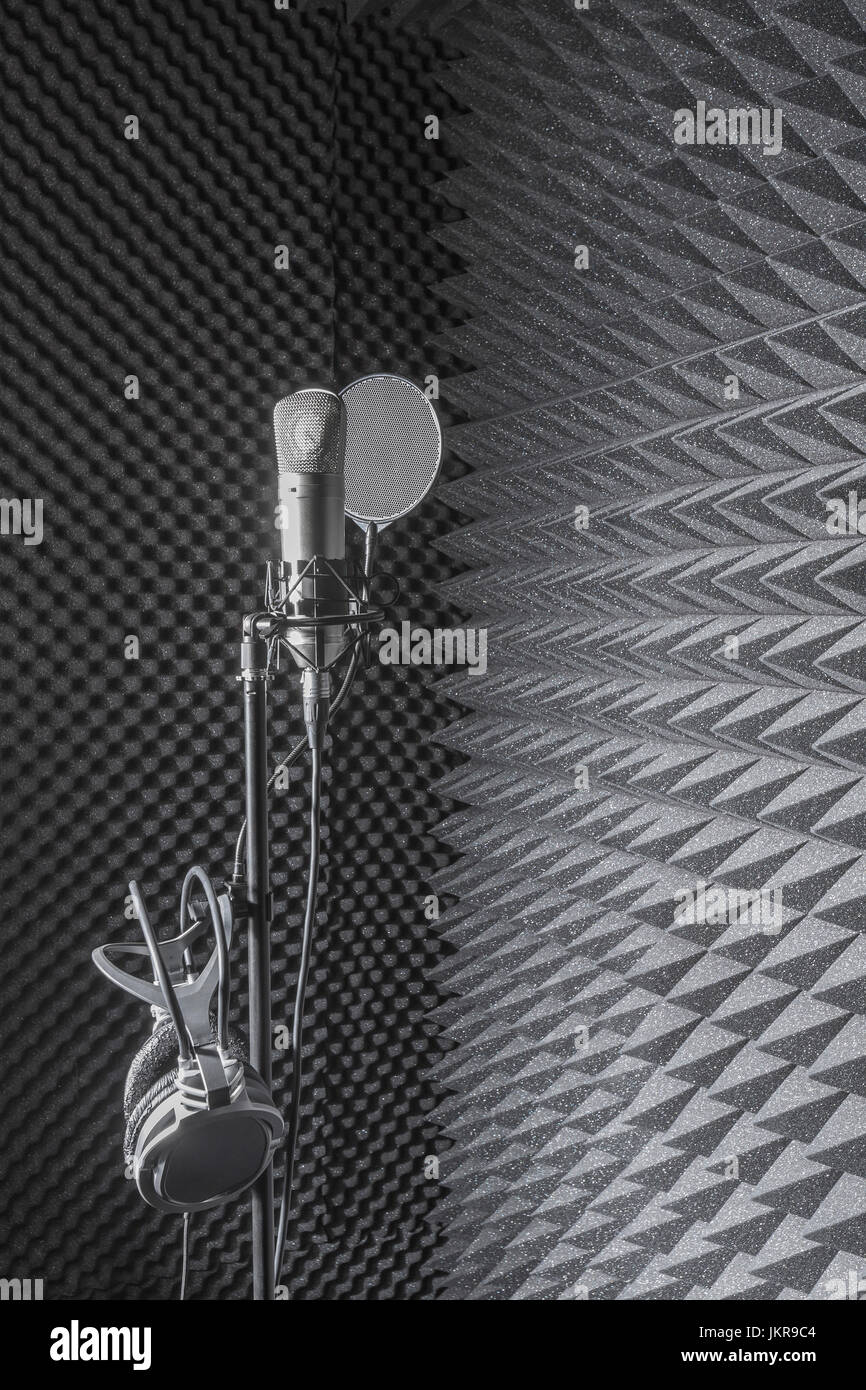 Headphones on microphone stand at recording studio Stock Photo