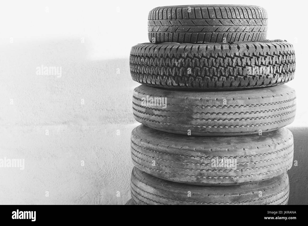 Stack of tires against wall Stock Photo
