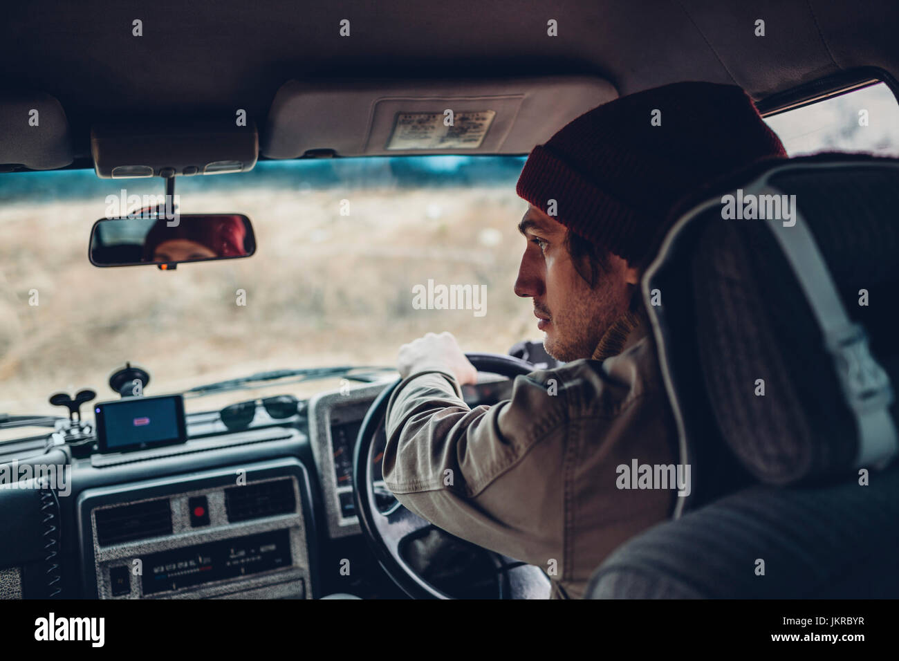 Rear view of man driving sports utility vehicle Stock Photo
