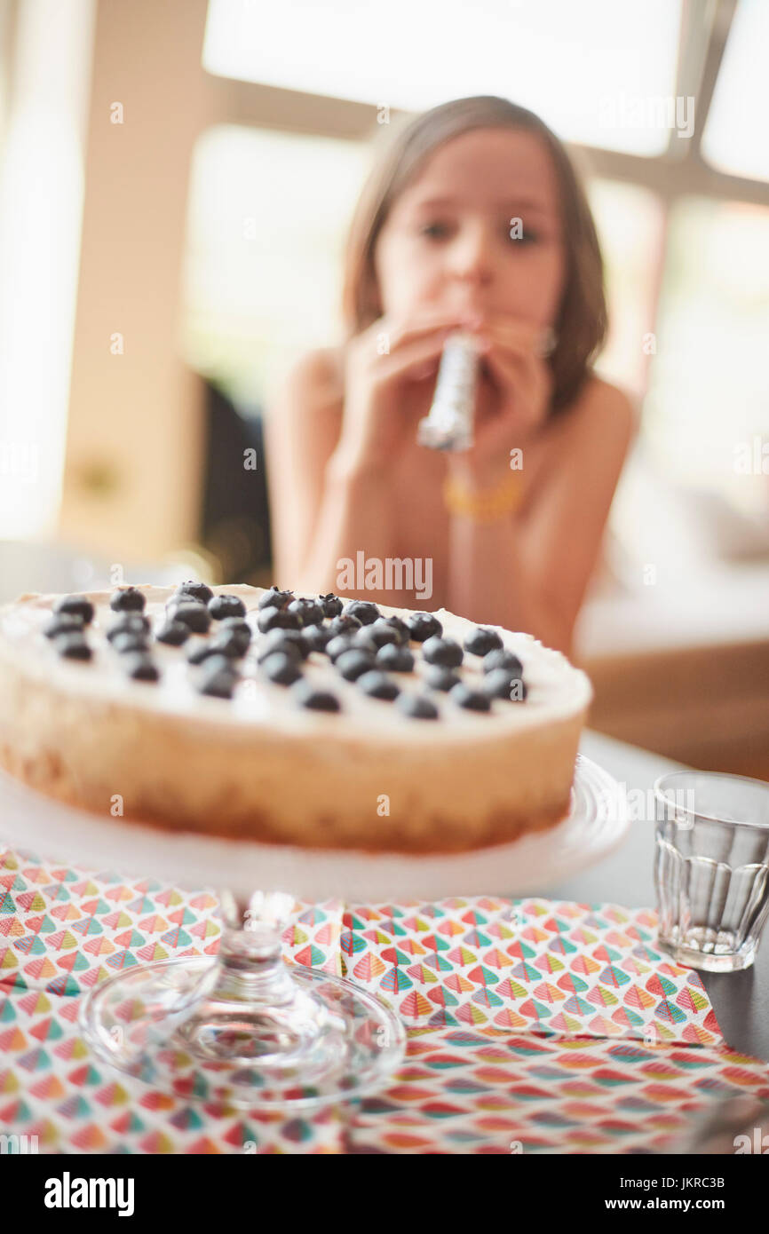 Cake on stand at table with girl in background Stock Photo - Alamy