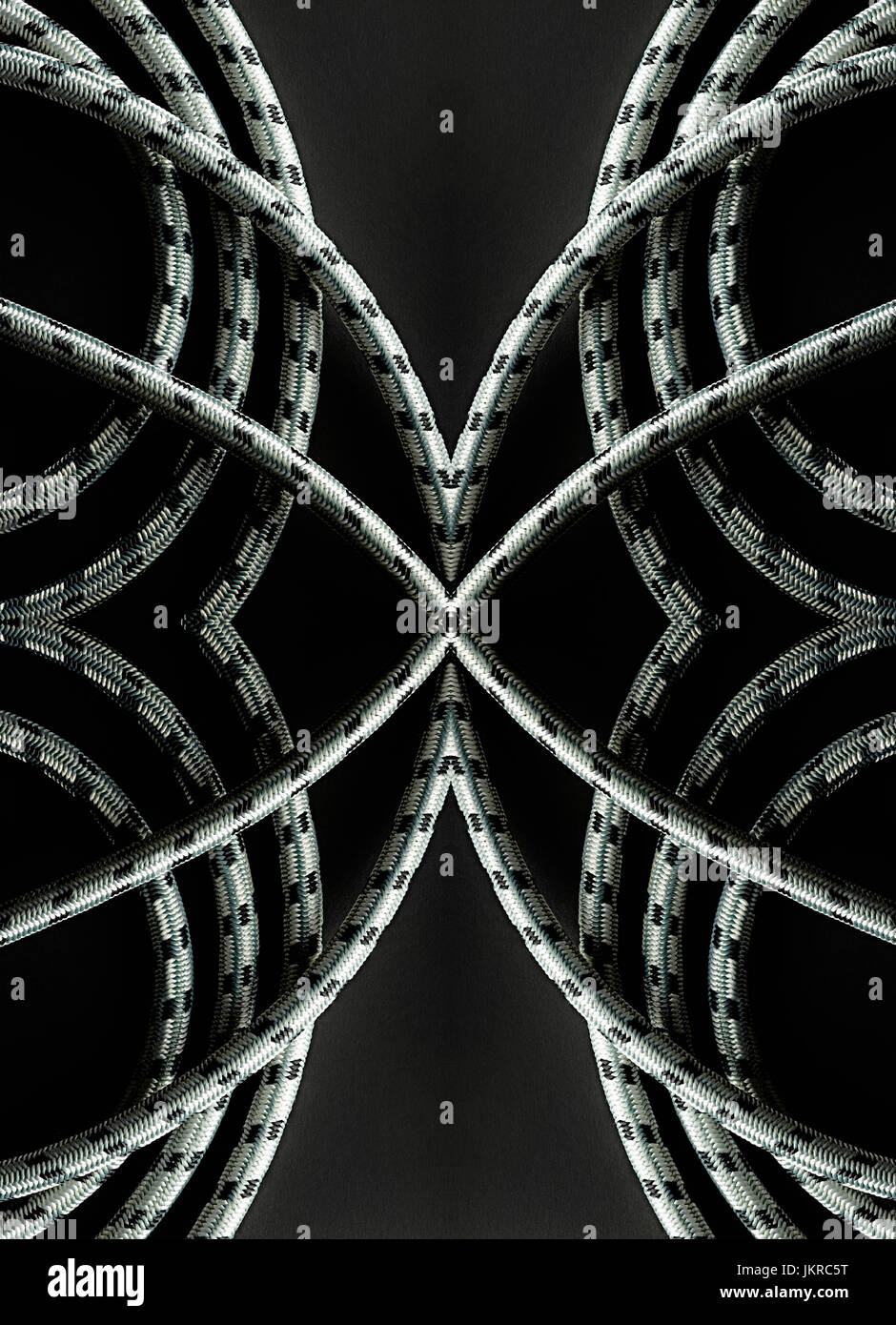 Kaleidoscopic image of ropes on black background Stock Photo