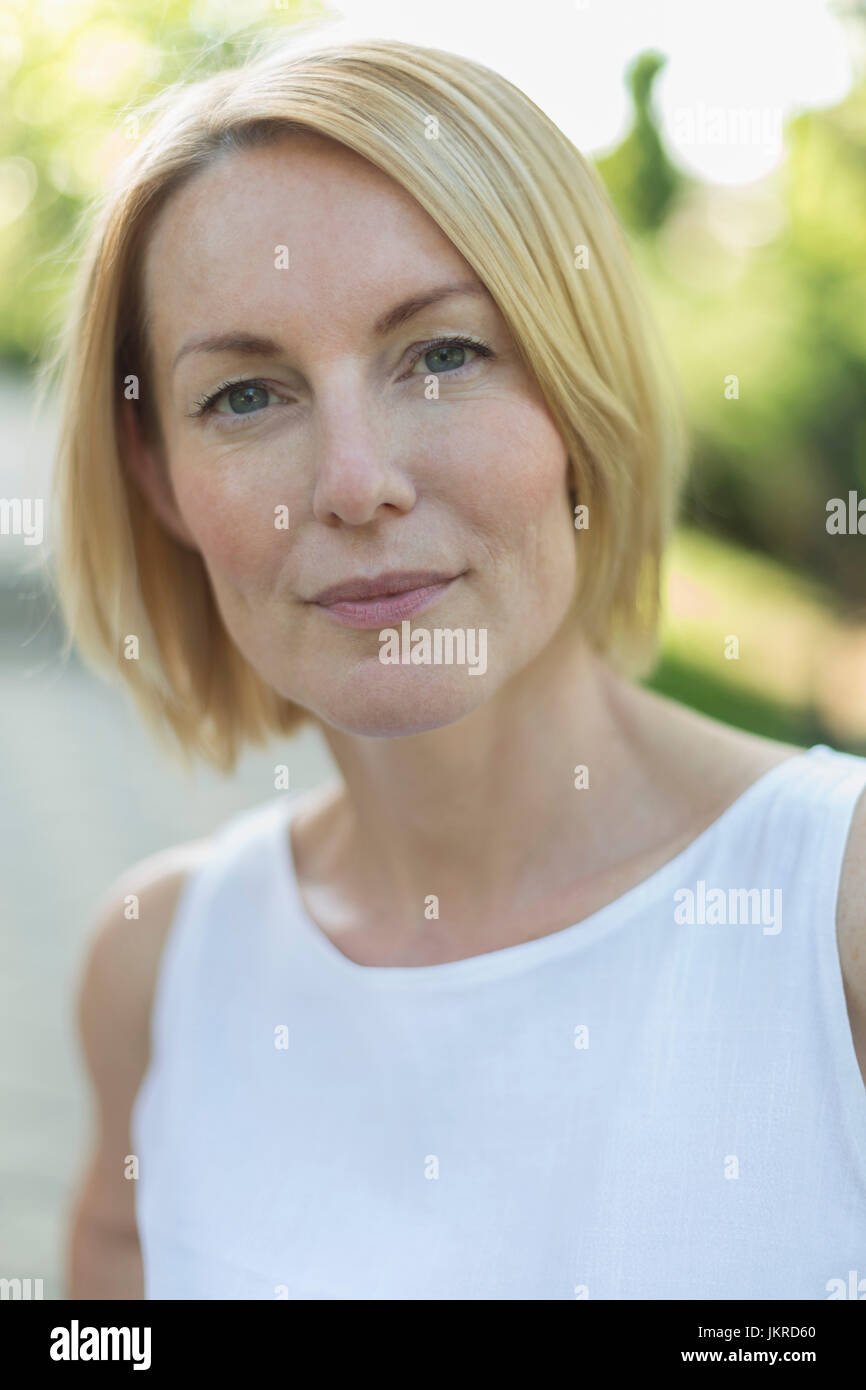Close-up portrait of mature woman with short blond hair Stock Photo