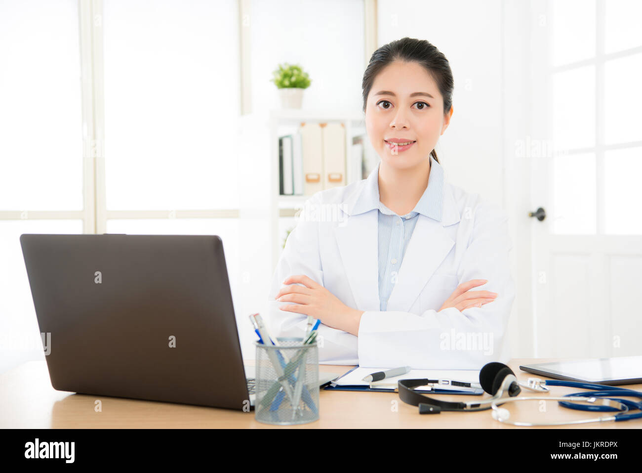 beautiful doctor working at medical office connect relation her treatment patient by internet with computer through online system caring person health Stock Photo