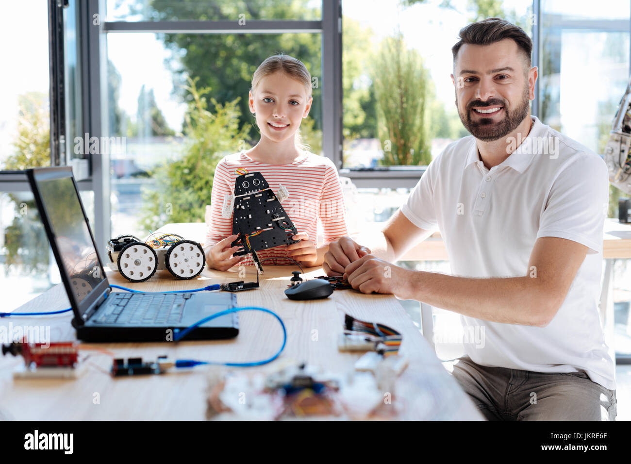 Pleasant girl having robotics workshop with her teacher Stock Photo