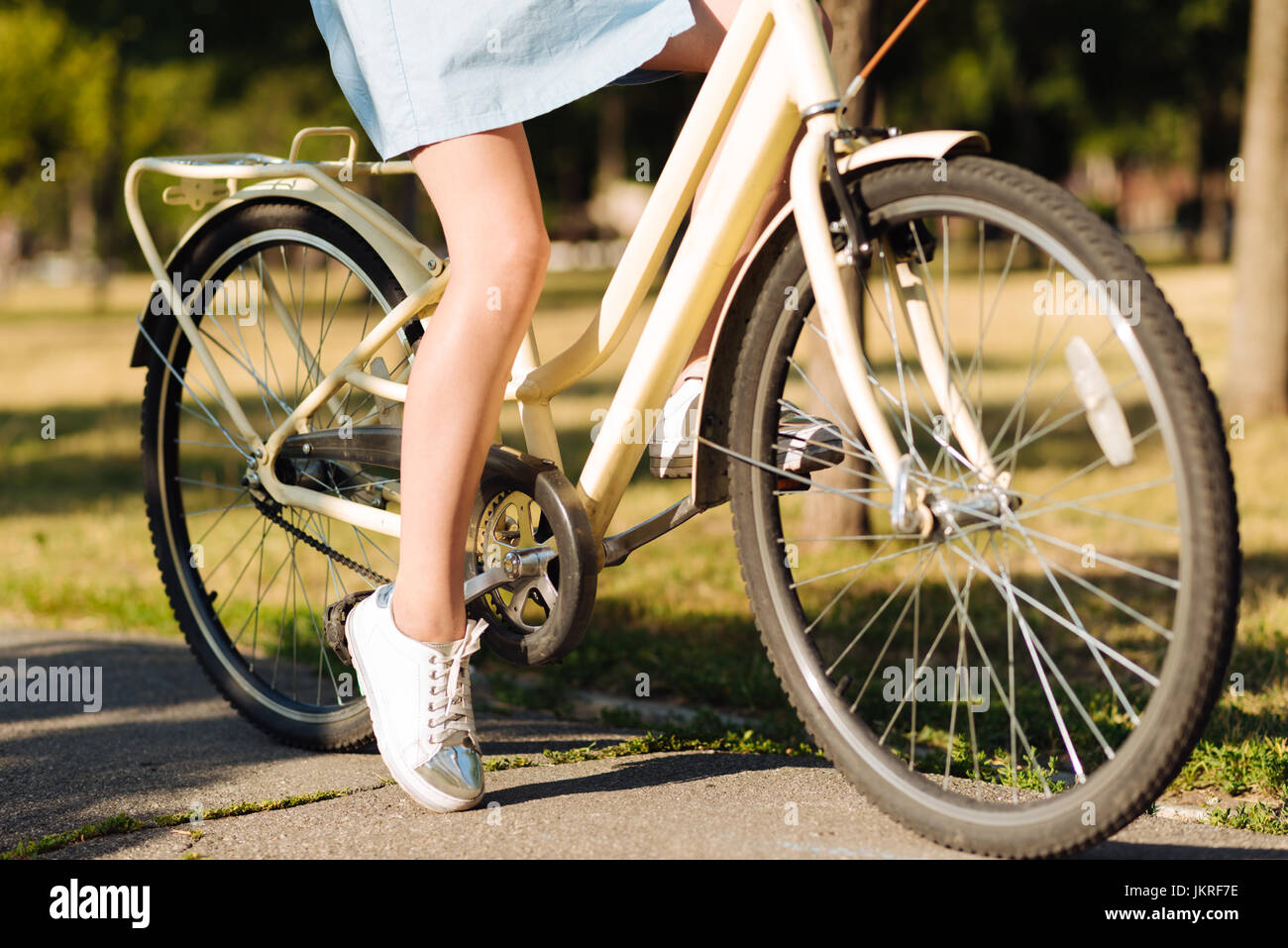 Young girl resting in the park with bicycle Stock Photo