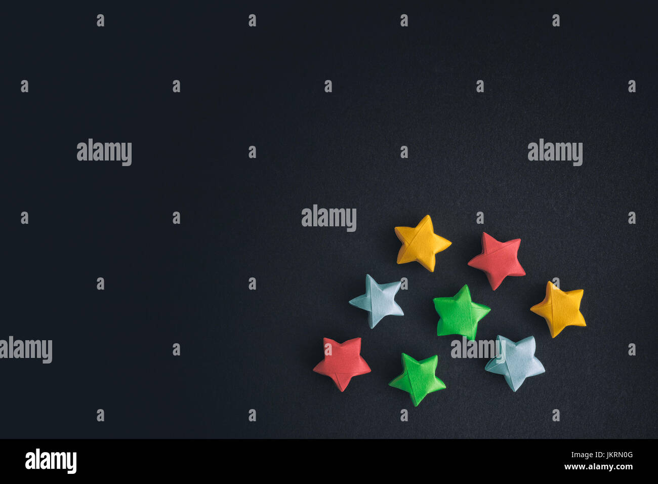 Colorful origami lucky stars on gray paper background Stock Photo - Alamy