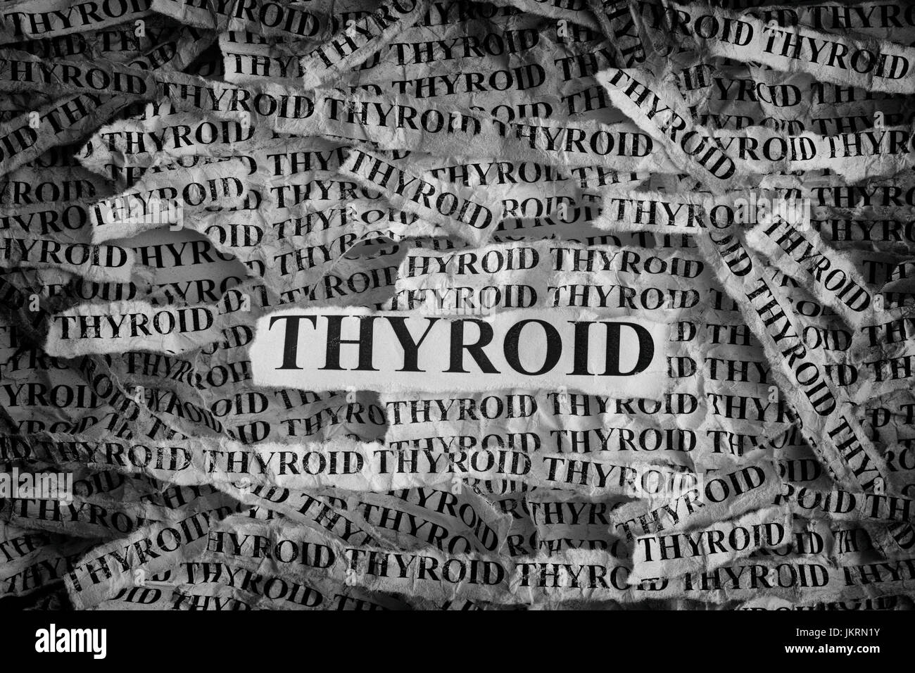 Thyroid. Torn pieces of paper with the words Thyroid. Concept Image. Black and White. Closeup. Stock Photo