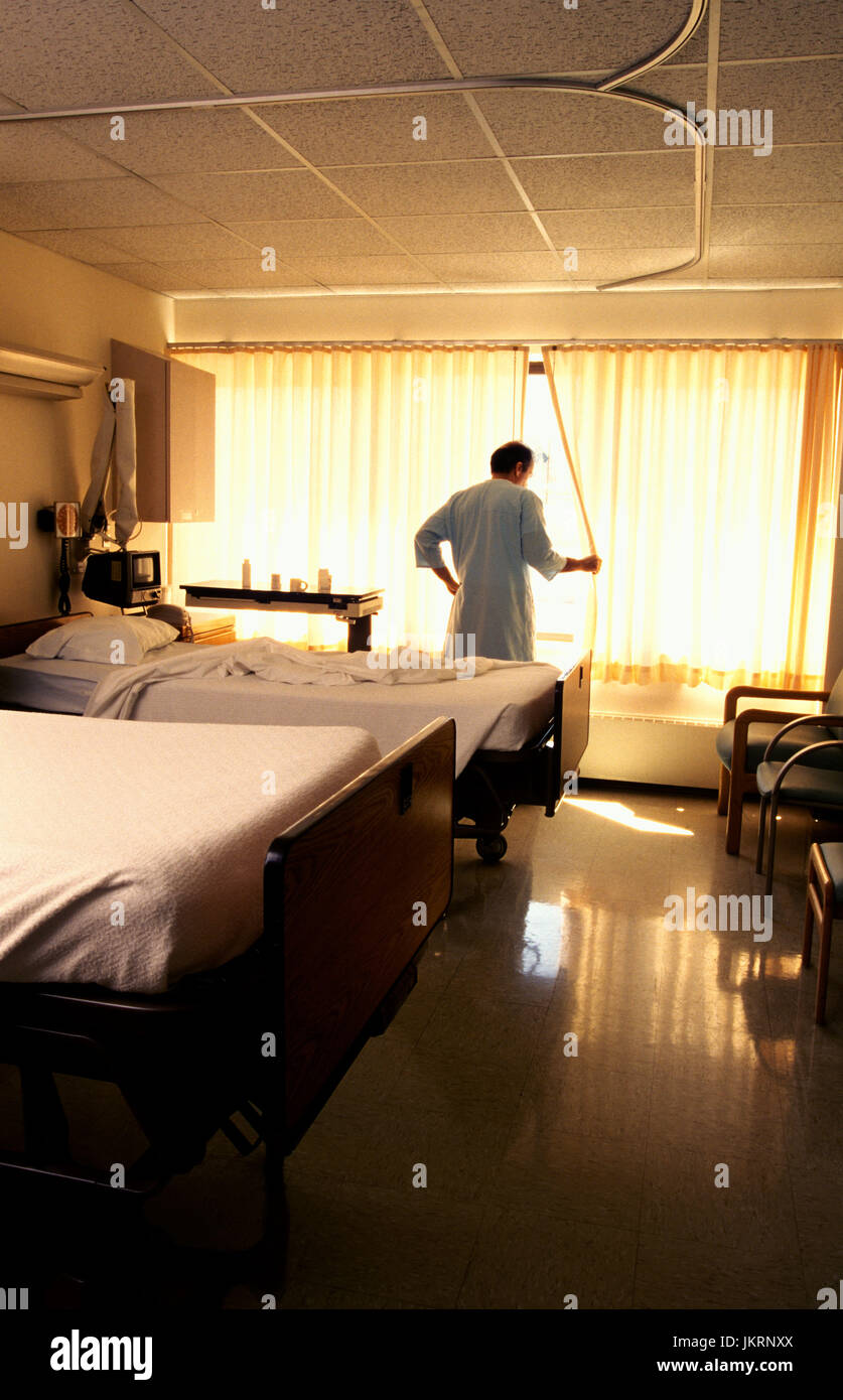 A patient thinking in his hospital bed. Stock Photo