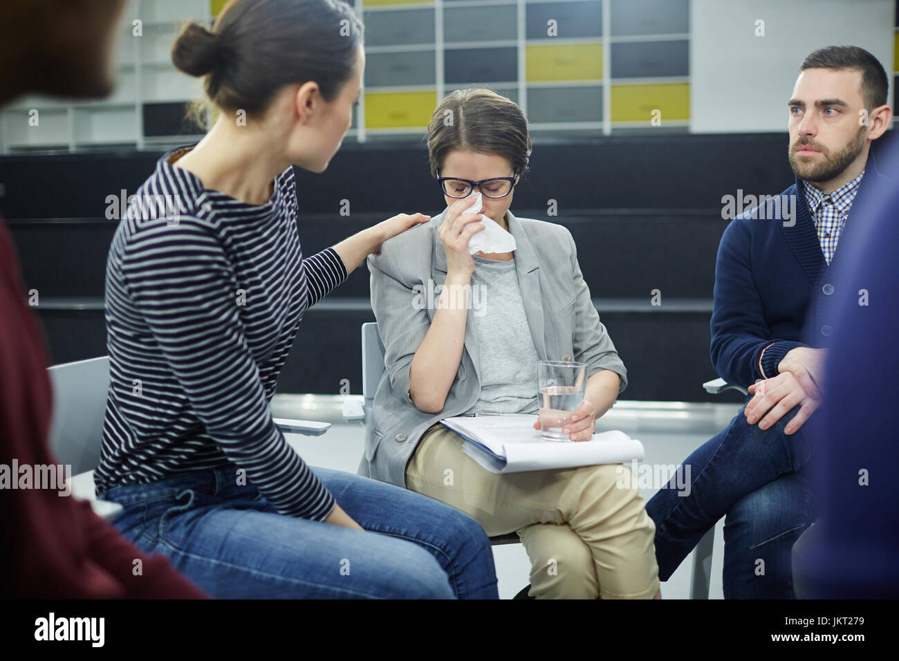 Young woman comforting her crying groupmate Stock Photo