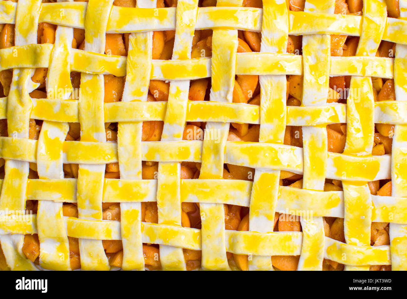 Unbaked homemade fruit sweet pie golden crust pattern Stock Photo