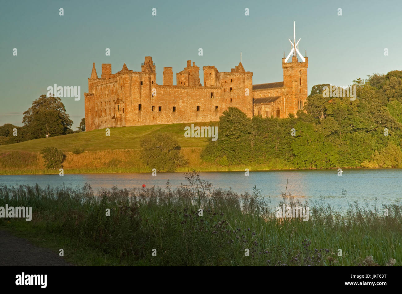 Evening sunlight over Linlithgow Loch and Palace Stock Photo