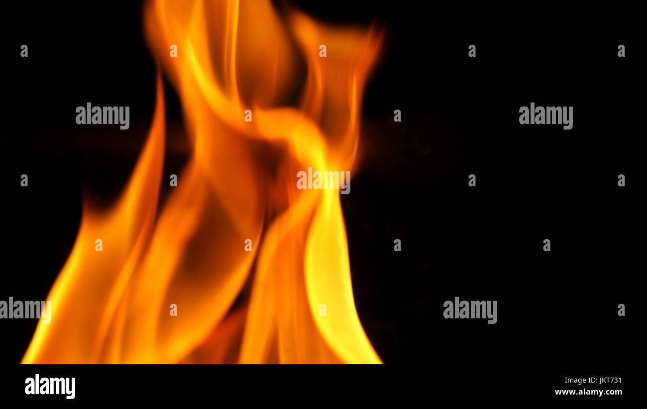 Fire blazing while cooking on black color background and close-up shot ...