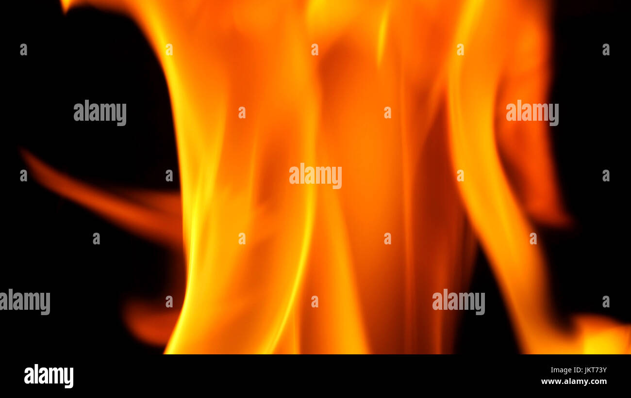 Fire blazing while cooking on black color background and close-up shot ...