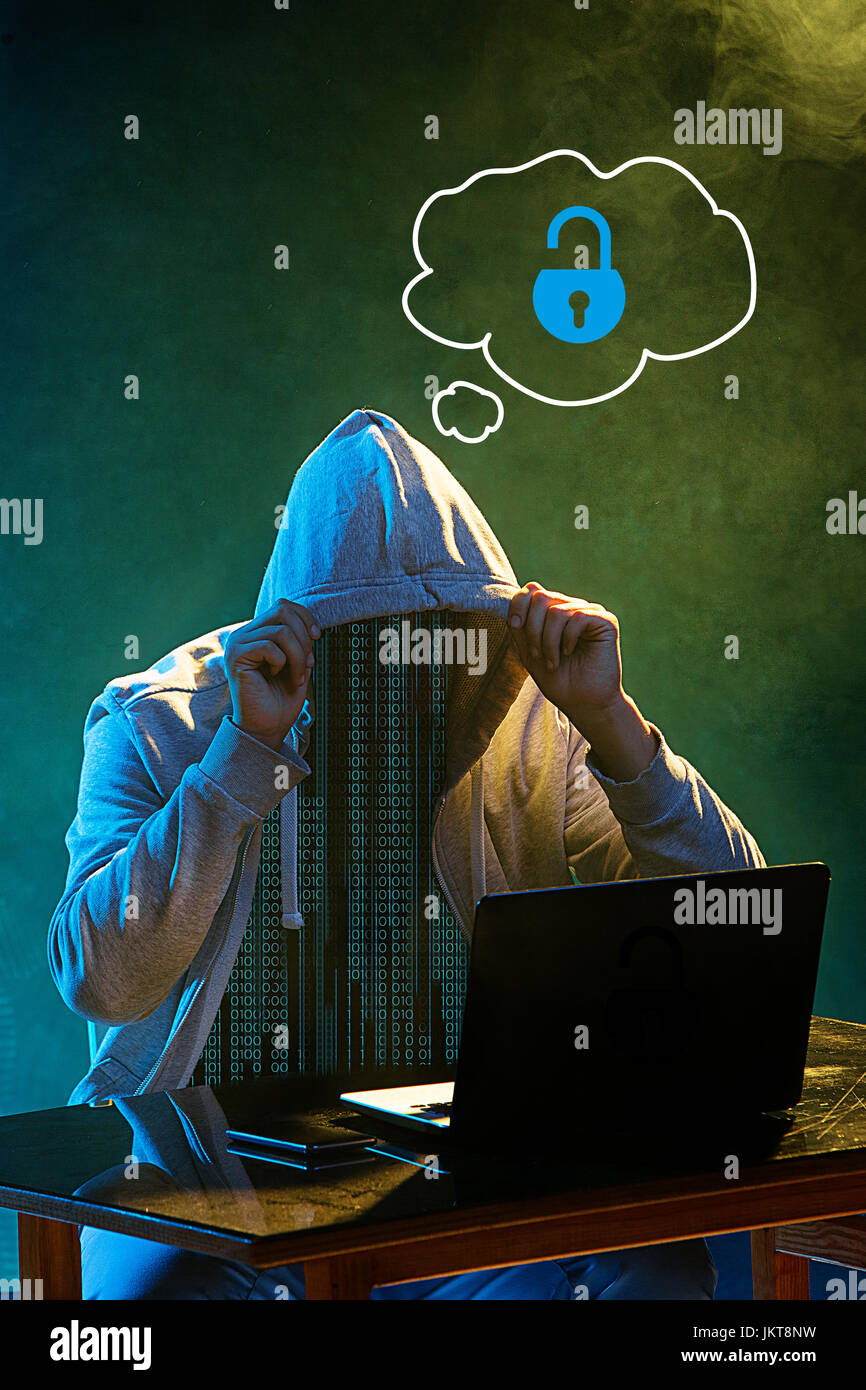 Hooded computer hacker stealing information with laptop Stock Photo - Alamy