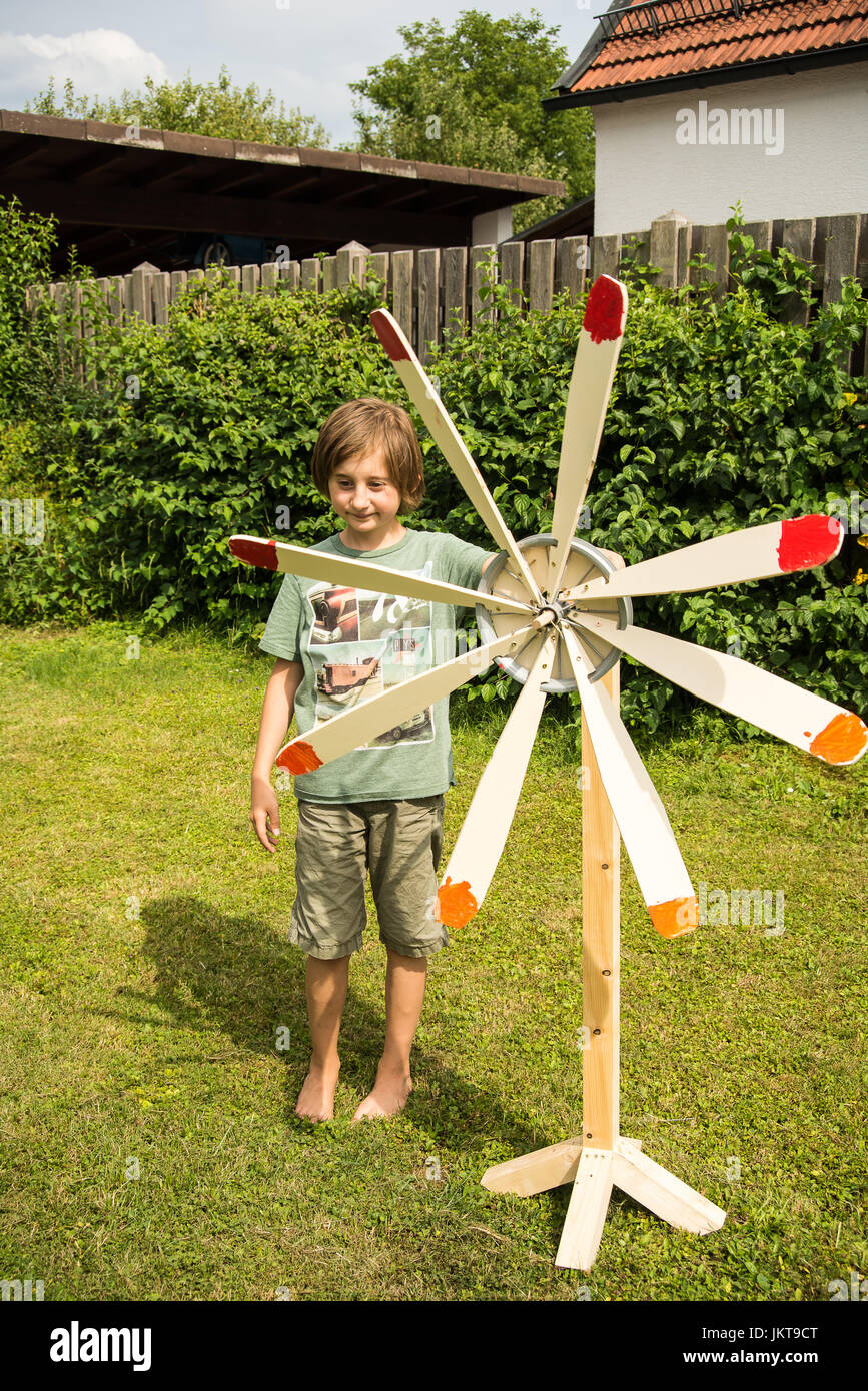 Windmill Boy A boy stands next to a wind mill he built at school Stock Photo - Alamy