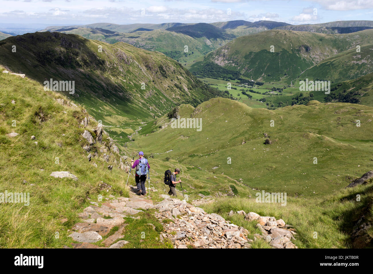 Walkers Descending Towards Dovedale From Dove Crag, Lake District, Cumbria, UK Stock Photo