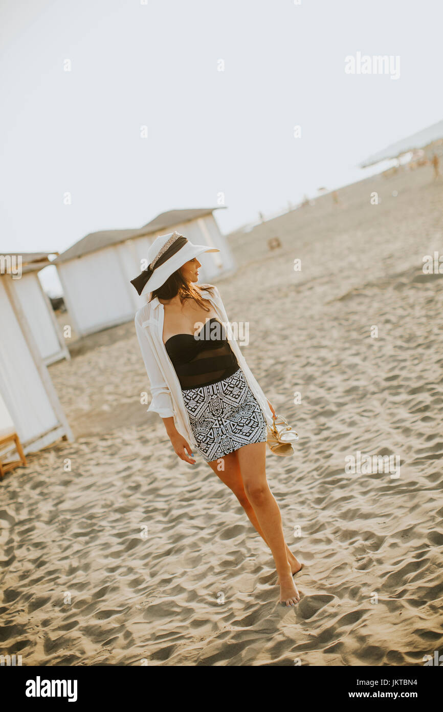 View at young woman posing on the beach Stock Photo - Alamy