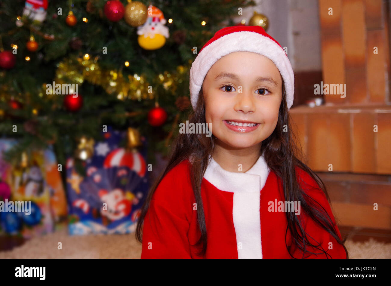 Beautiful smiling litle girl wearing a christmas clothes with a