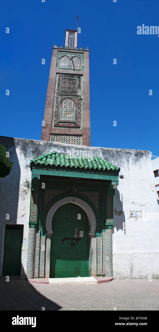 The minaret of the mosque in Place Aissawa, Aissawa Square, in the Medina area of the old town of Tangier, the african city on the Maghreb coast Stock Photo