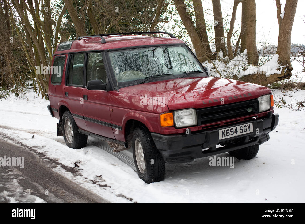 Land Rover Discovery in snow at side of road Stock Photo