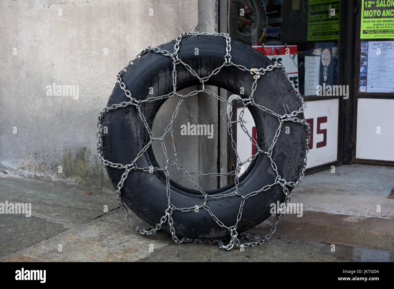 Snow chains on large tractor wheel Stock Photo Alamy