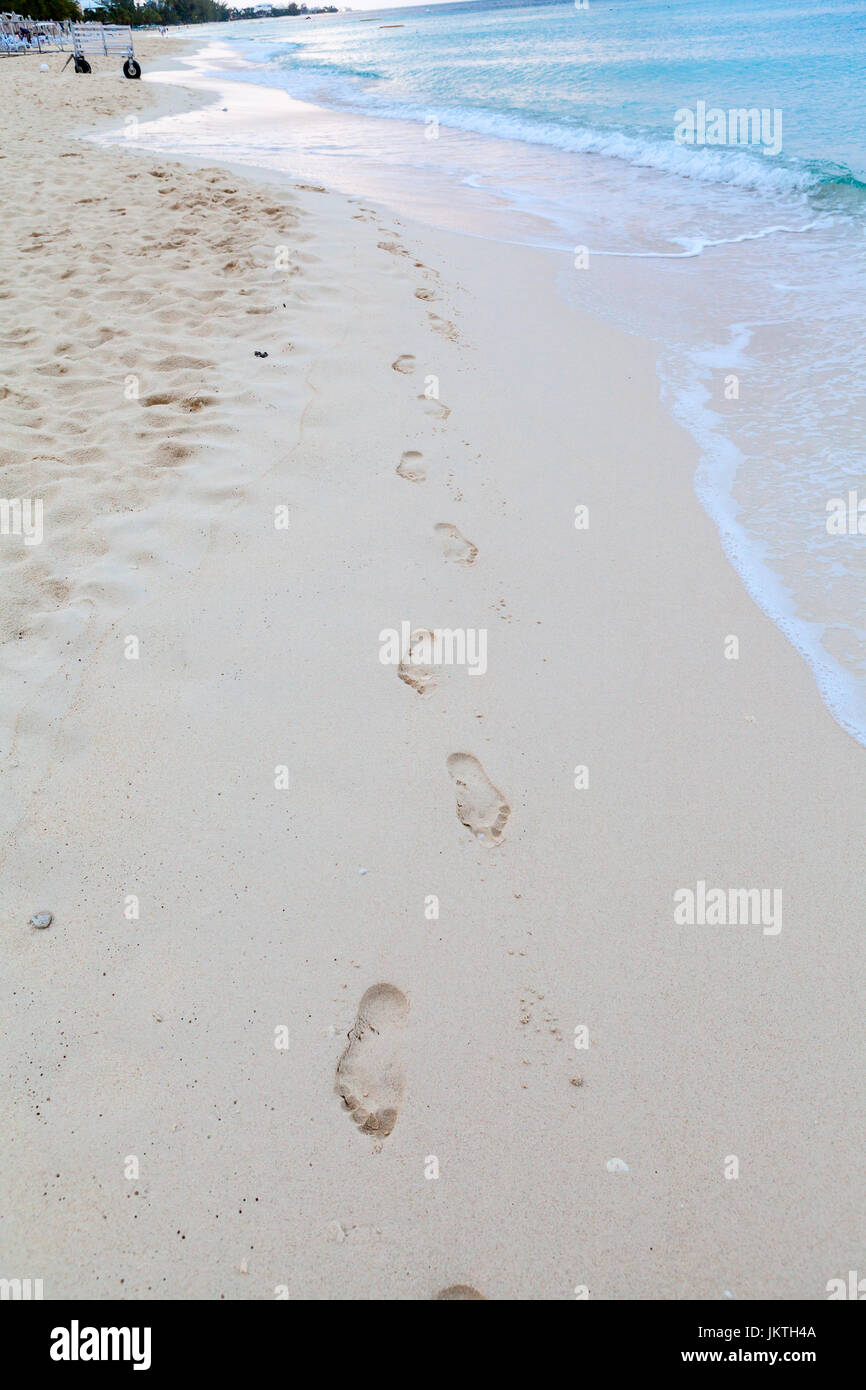 Human footprints on the shore of the beach , Grand Cayman resort Stock Photo