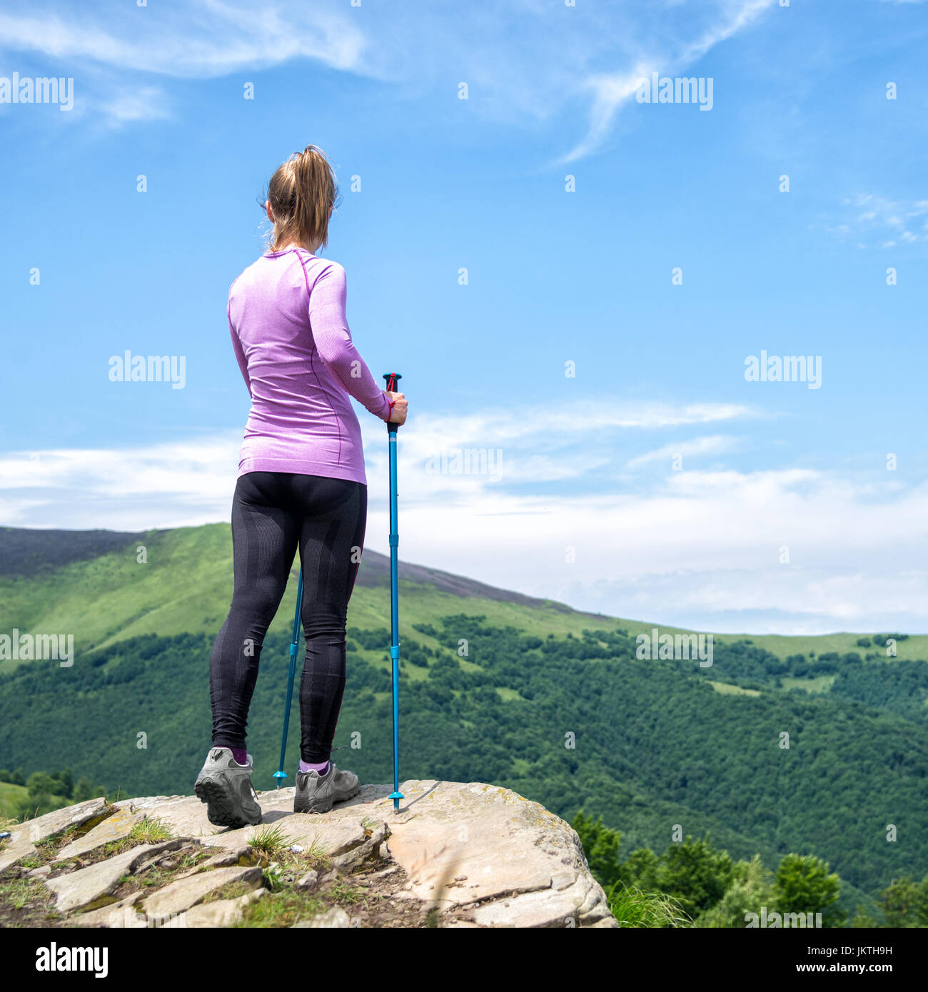 Young woman hiking in the mountains Stock Photo - Alamy