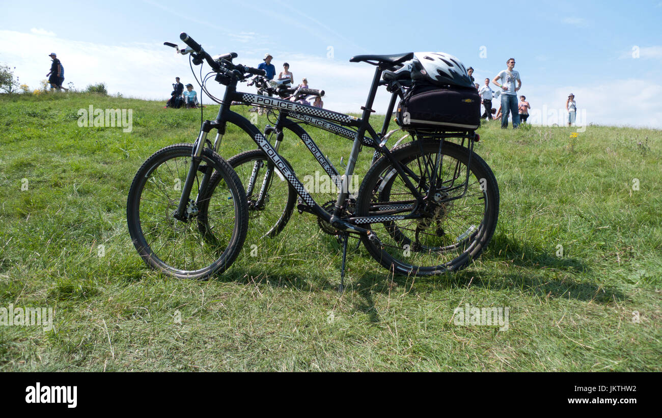 Two police mountain bikes in a field Stock Photo Alamy