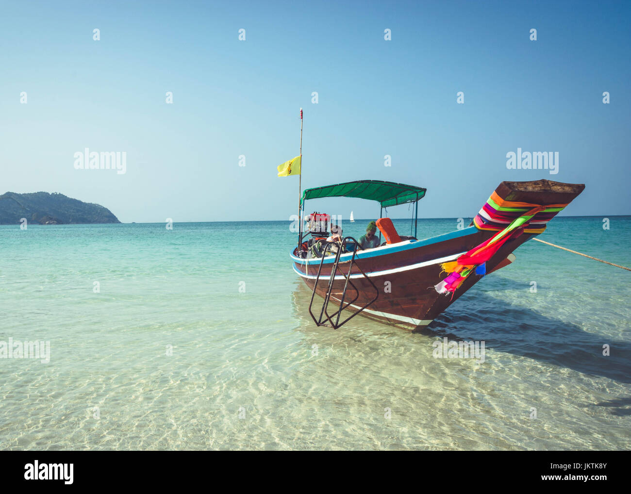 A boat is anchored at Bottle Beach, Koh Pha Ngan, Thailand. Southeast Asian travel, through the scenic islands of Thailand. Stock Photo