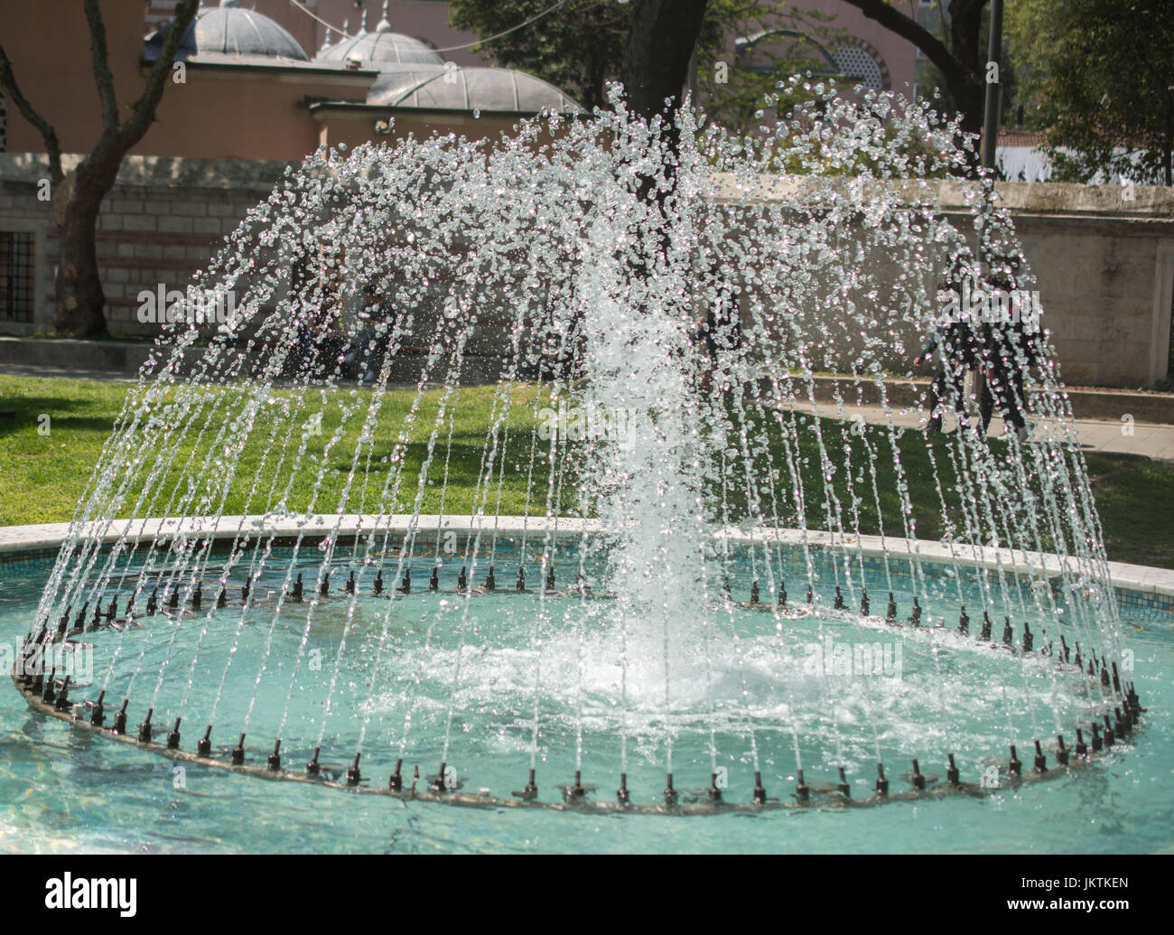 The fountains gushing sparkling water in a pool in a park Stock Photo