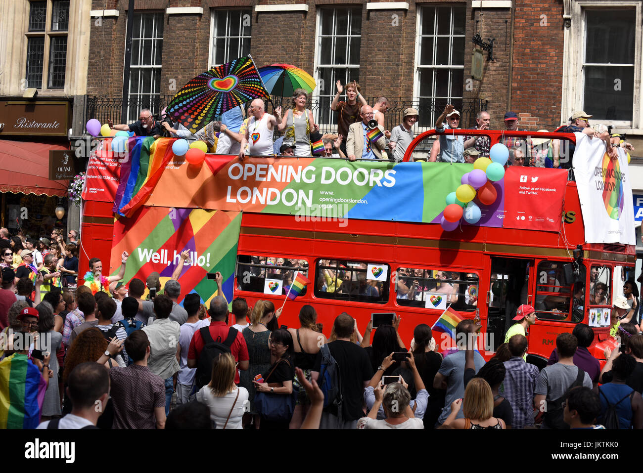 Supporters of the Opening Doors London charity drive on the double-decker red bus through central London at the Pride in London parade, 2017. Stock Photo
