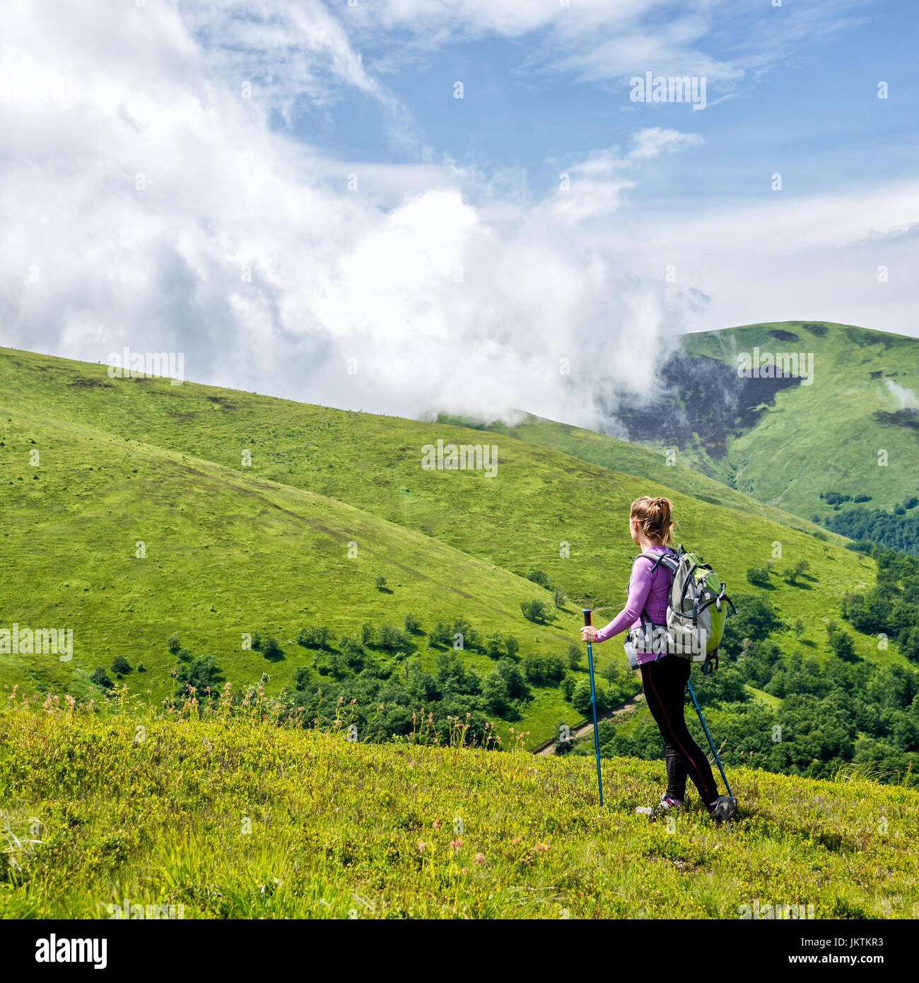 Young woman hiking in the mountains Stock Photo - Alamy