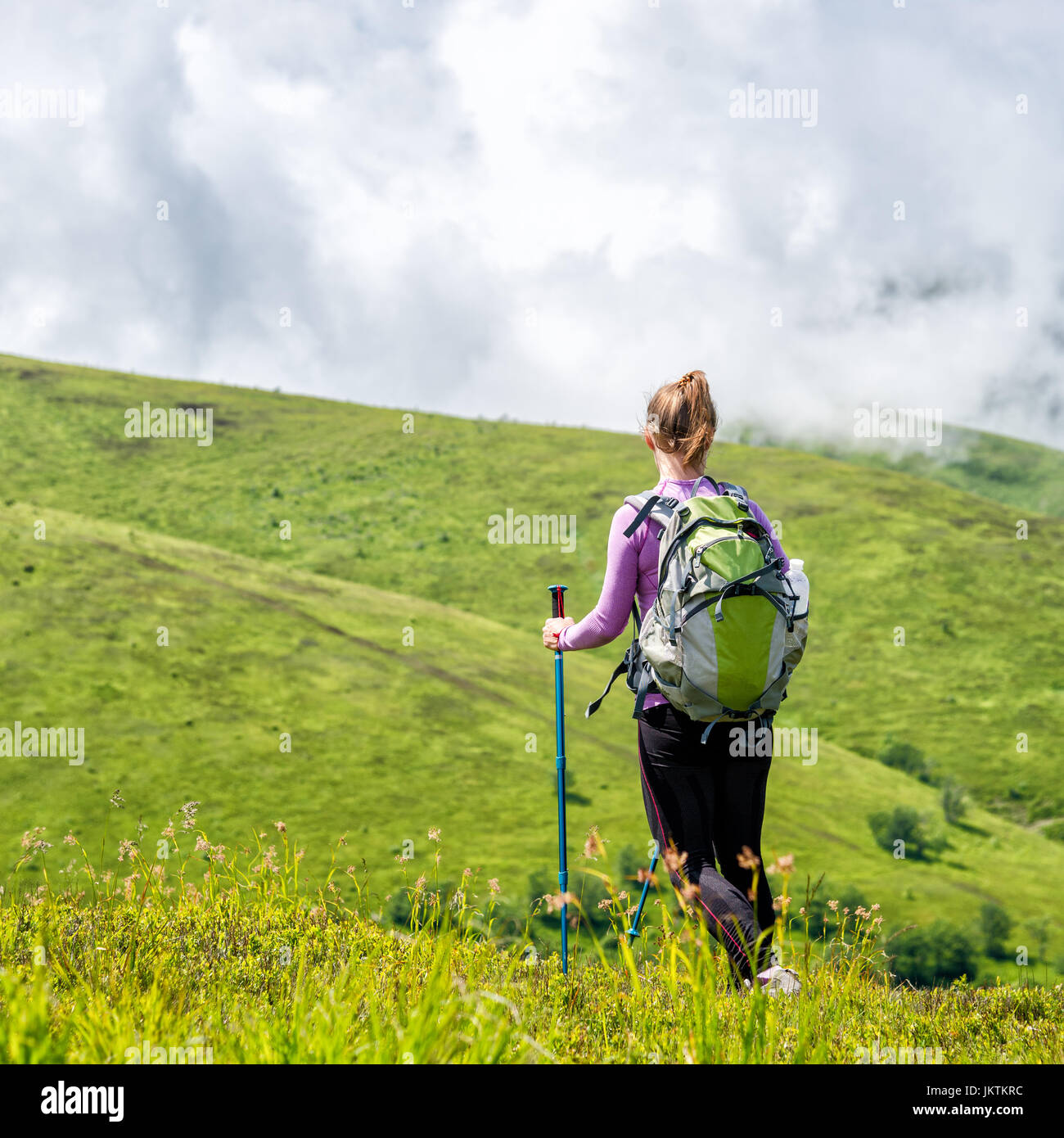 Young woman hiking in the mountains Stock Photo - Alamy