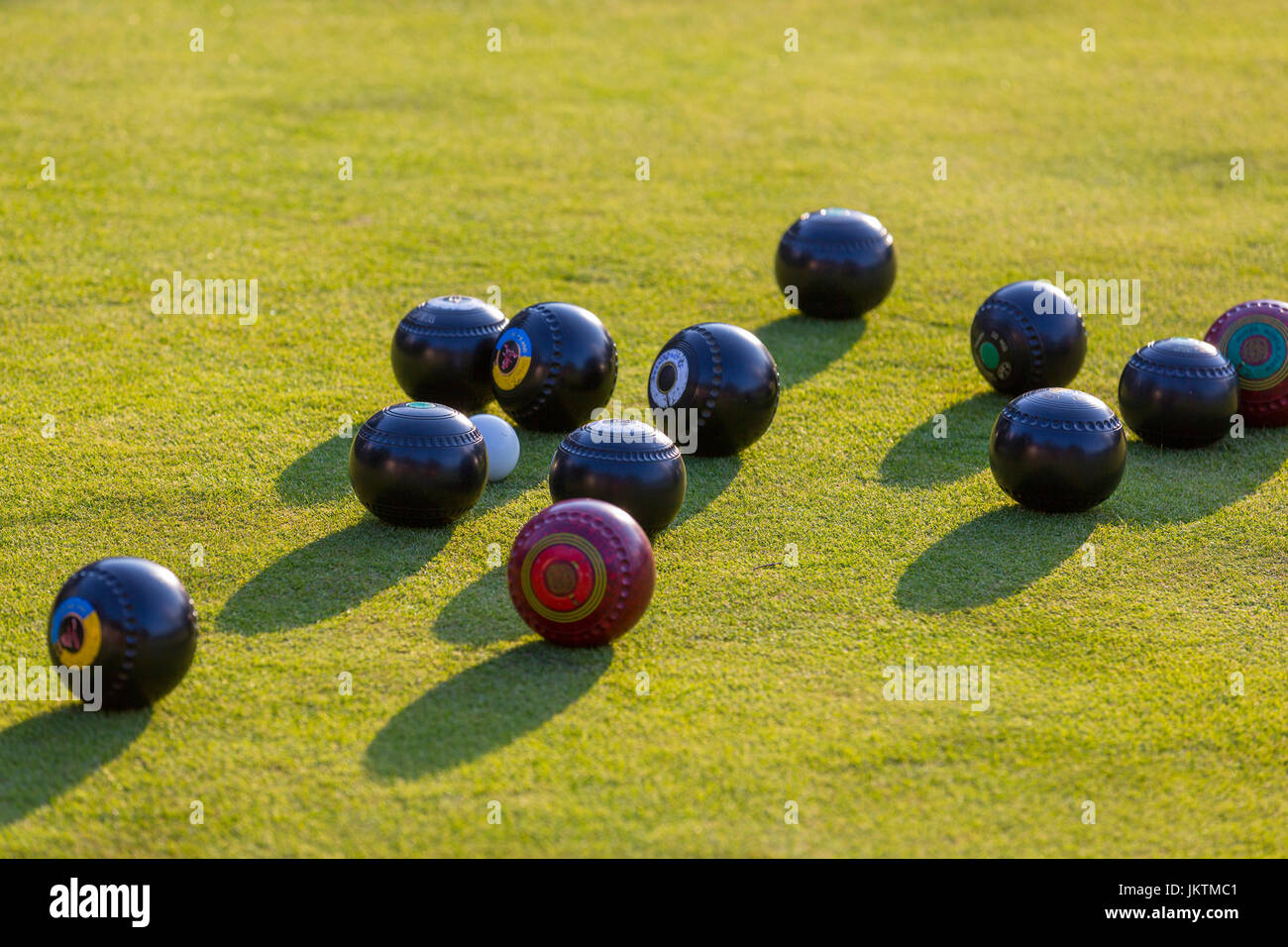 Bowls surrounding the jack on a bowling green. Stock Photo