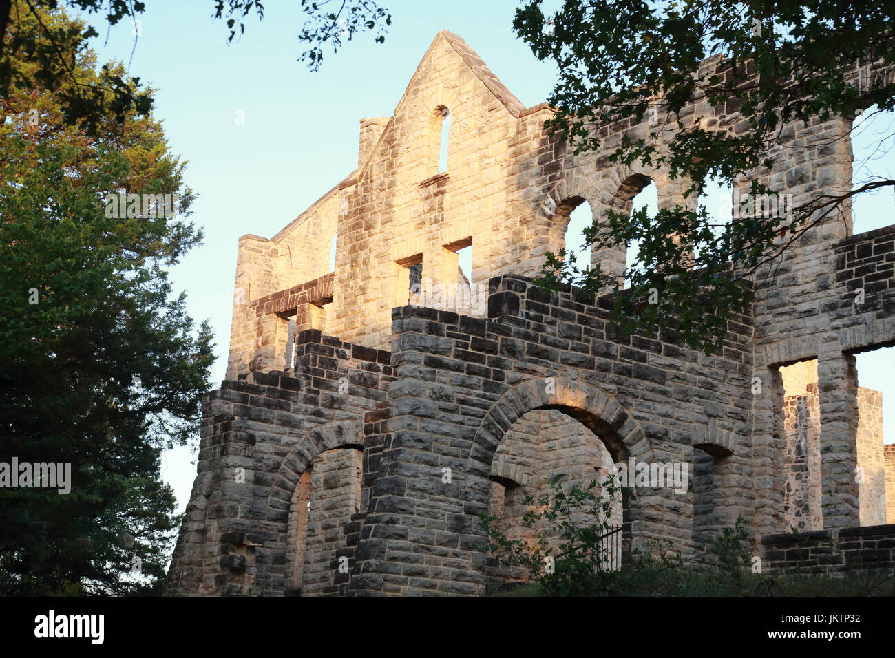 Stone walls of an ancient castle bathed in golden light at sunset in Ha ...
