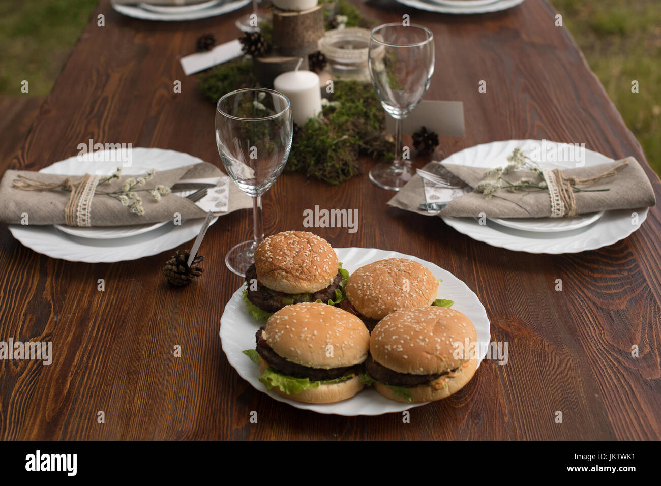 Table setting with served hamburgers Stock Photo