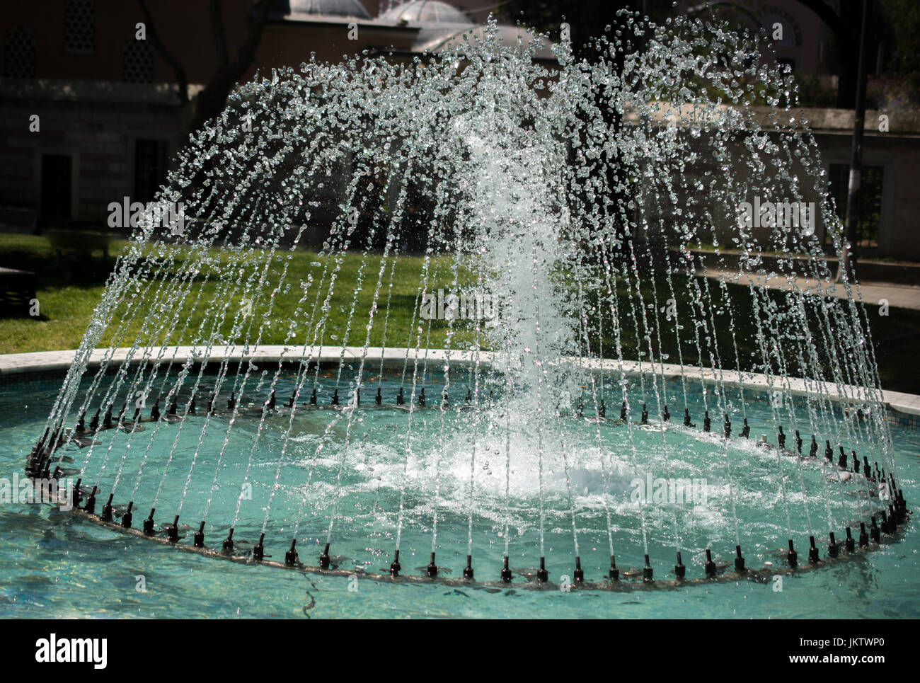 The fountains gushing sparkling water in a pool in a park Stock Photo