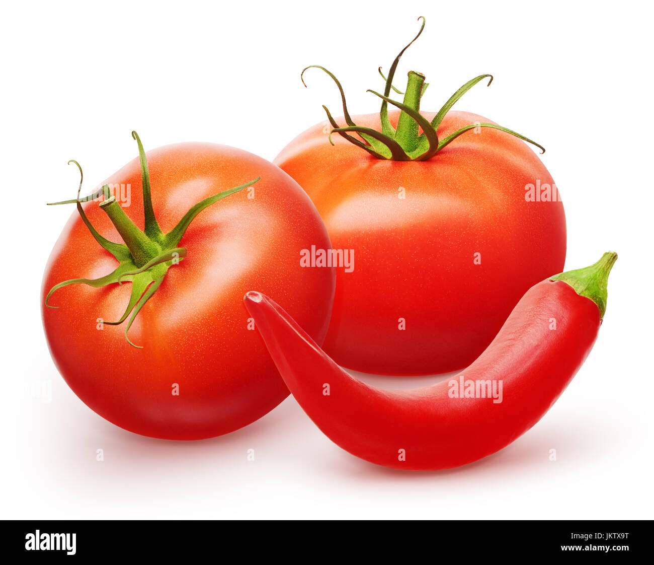 Two whole fresh red tomatoes with green leaves and chili pepper ...