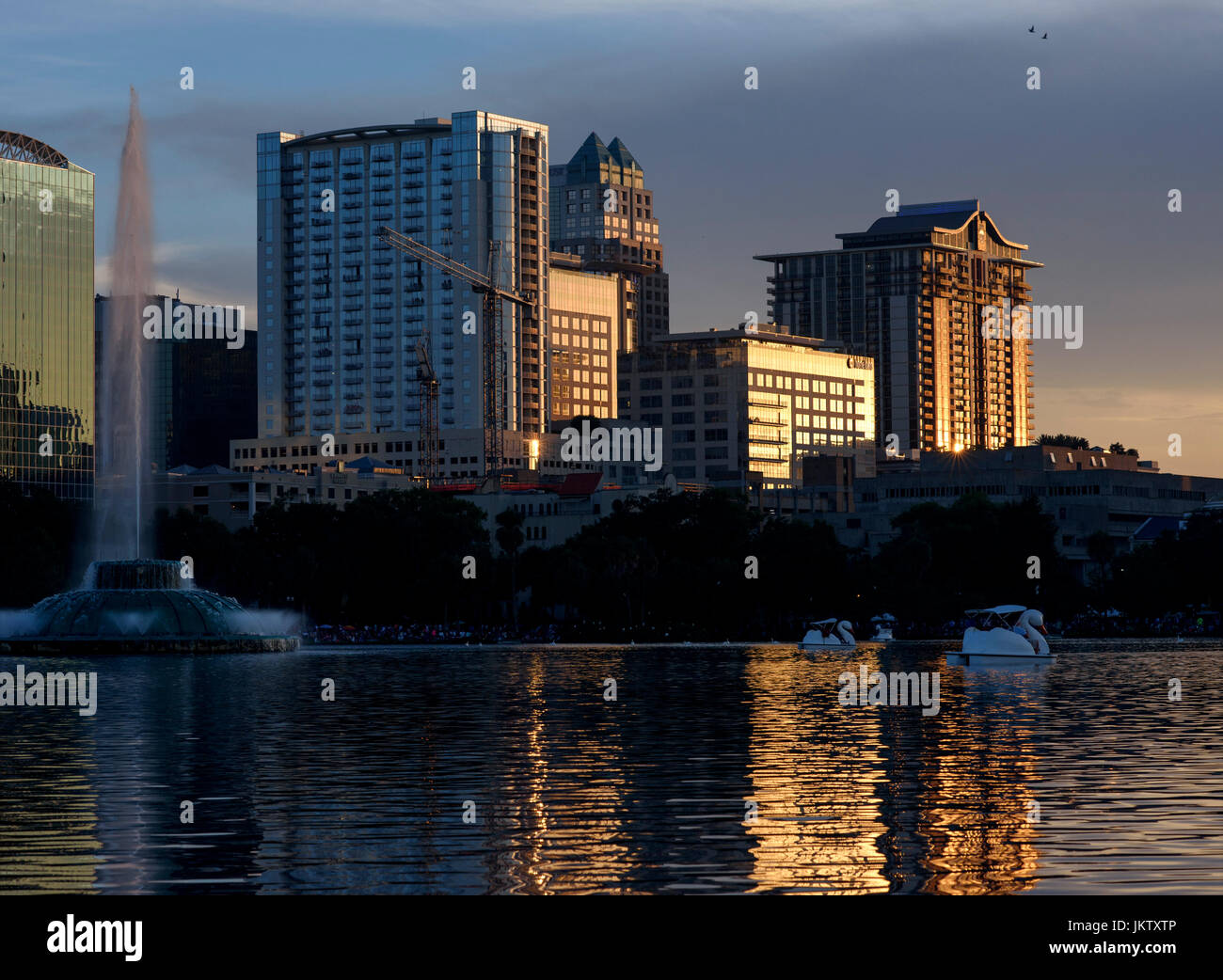 Swan shaped paddle boats at Lake Eola Park with the downtown Orlando skyline in the background on the Fourth of July. Stock Photo