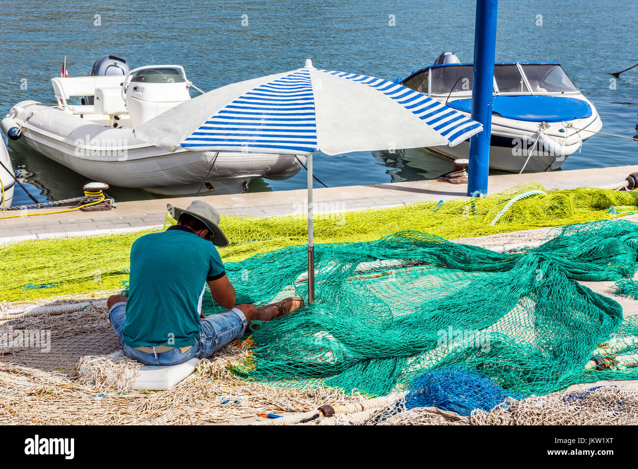 Fisherman mending nets in Port d'Andratx, Majorca, Balearic Islands, Spain, Europe Stock Photo