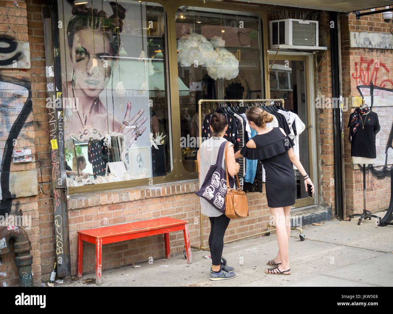 Shoppers browse the racks of a clothing store in the Williamsburg neighborhood of Brooklyn in New York on Saturday, July 22, 2017. The MTA will eventually be shutting down the L train to repair the tunnel, damaged by Superstorm Sandy. Businesses are worried about their lifeline of tourists being unable to conveniently access the neighborhood. (© Richard B. Levine) Stock Photo