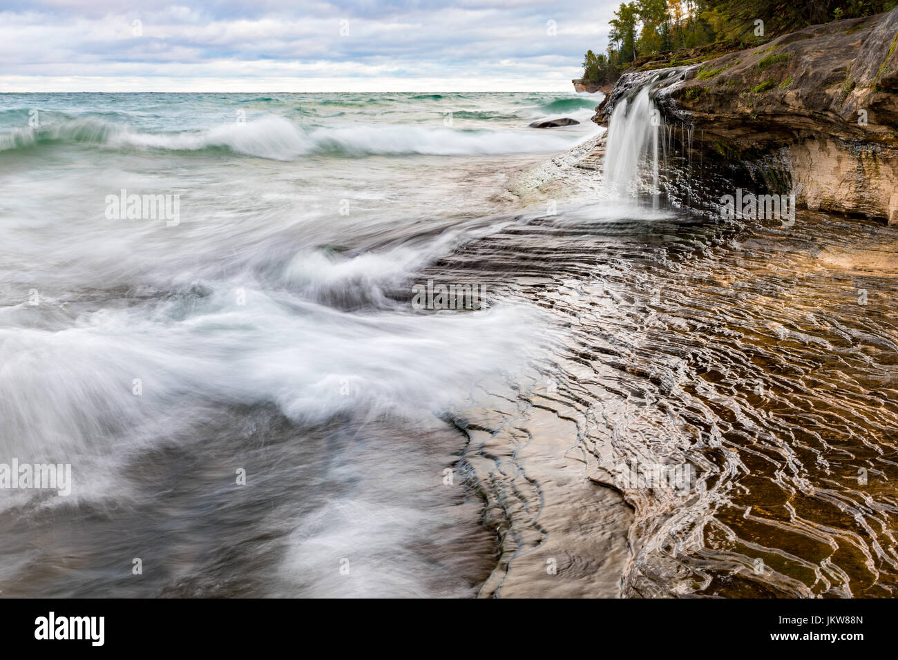 Elliot Falls flows into Lake Superior on Miners Beach at Pictured Rocks National Lakeshore. Located in Munising, Michigan in the Upper Peninsula Stock Photo