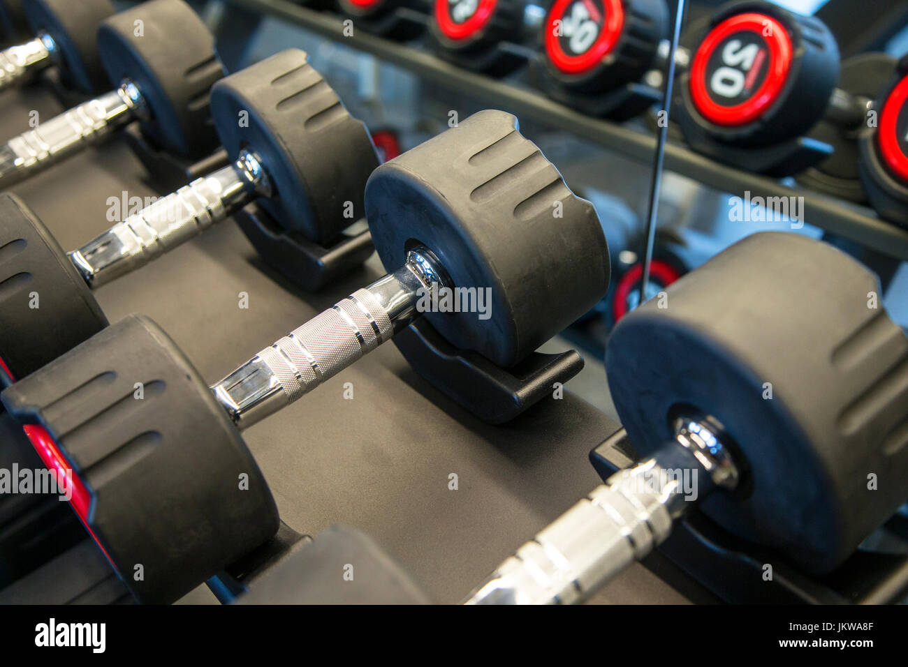 Dumbbells on a rack Stock Photo - Alamy