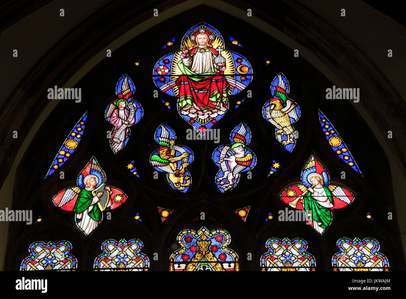 Jesus resurrected, symbols of four Evangelists, angel musicians, tracery, stained glass window, by William Wailes, 1853, Swaffham, Norfolk, EnglandUK Stock Photo