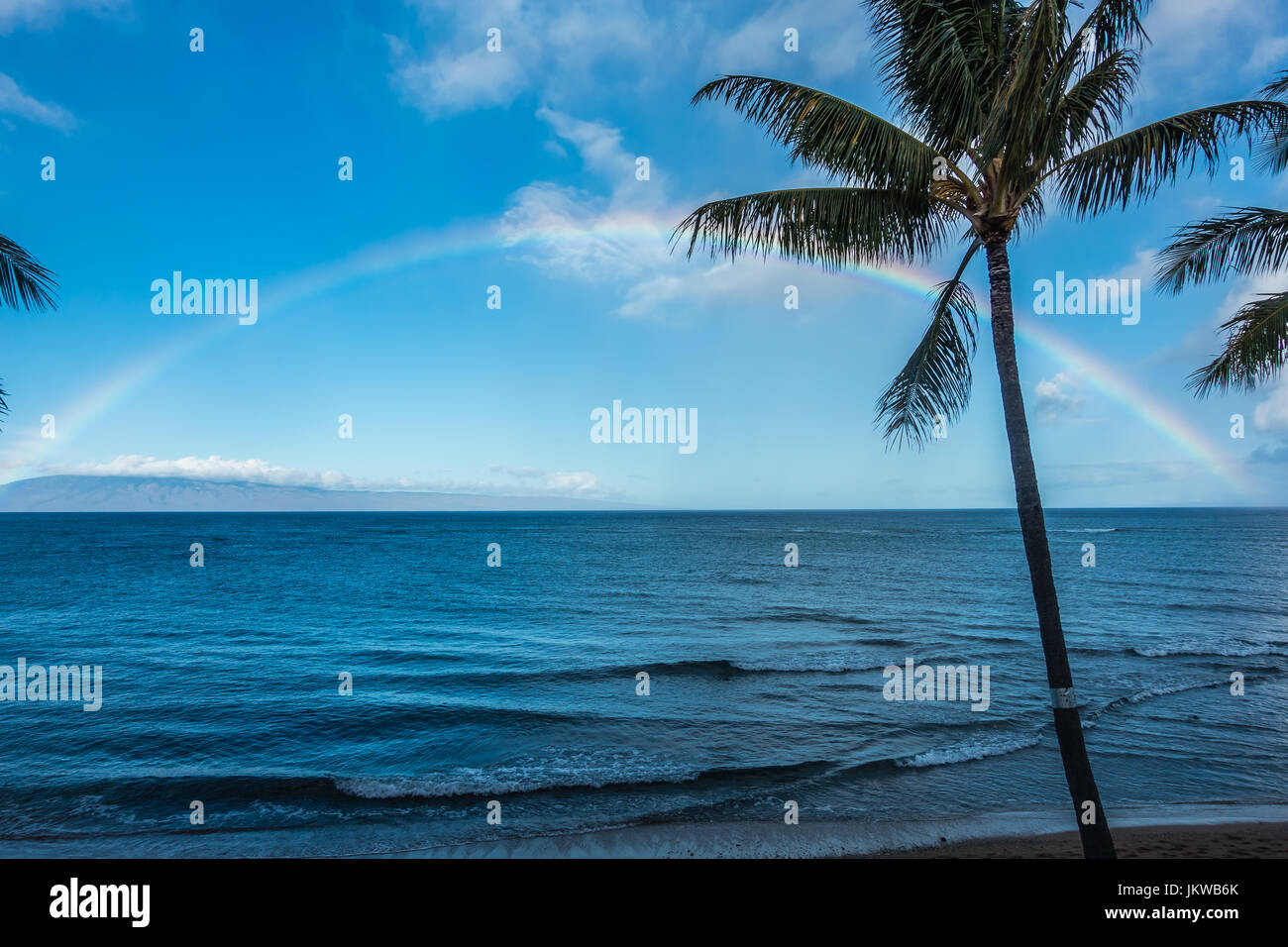A view of a rainbow over the ocean in Maui, Hawaii Stock Photo - Alamy