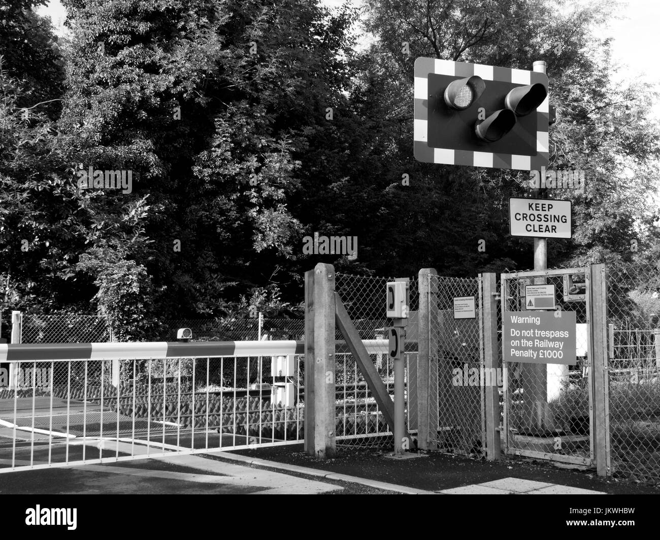 Rural Railway Level Crossing With Barriers Down Across Roadway For Approaching Train With Warning Signs And Lights Stock Photo Alamy