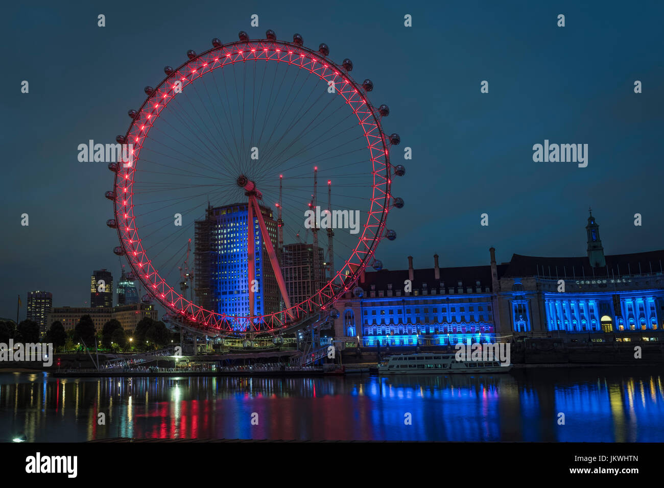 London Eye at Night with Thames Reflections Stock Photo